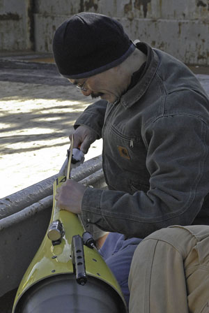 Marine scientist Craig Lee finishes assembly of an underwater glider.: Photograph courtesy of University of Washington